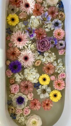 flowers floating in a bathtub filled with water