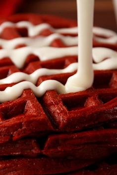 a red waffle with white icing on it