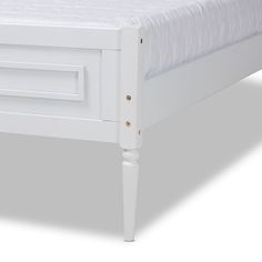 a white bed frame with no sheets on it and an open drawer under the mattress