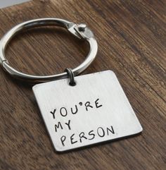 a metal keychain with the words you're my person on it