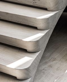 a close up view of the back end of a bench made out of marble blocks