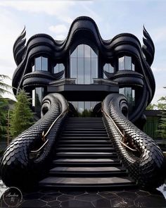 an artistic building with large black tires on the steps leading up to it's entrance