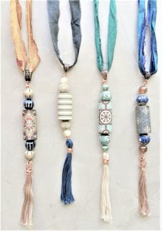 four different necklaces with tassels and beads