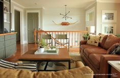 a living room filled with furniture and a flat screen tv mounted to the wall above it