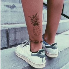 a person with a pineapple tattoo on their leg