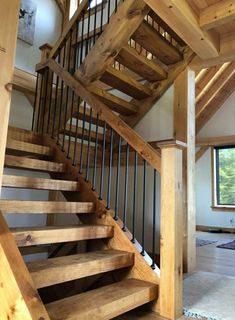 a wooden stair case in a large room