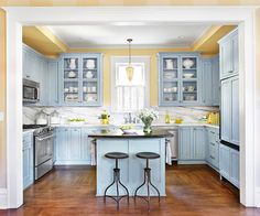 a kitchen with blue cabinets and wooden floors