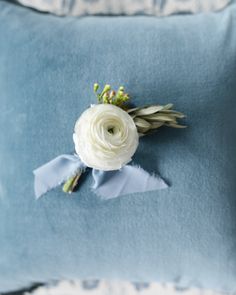 a blue pillow with a white flower on it