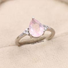 Natural Pink Quartz Pear Cut Engagement Ring, Rose Quartz Ring, Tear Drop Solitaire Ring, Healing Quartz Ring, Anniversary Gift for her --->Ring details: - Theme: Solitaire & Engagement - Metal Type: Sterling Silver, White Gold, Rose Gold , Yellow Gold - Main Stone: Natural Rose Quartz - Accented stones: Cubic Zircons - Color: Pink, White - Ring Size: I offer more than one (Contact us if your ring size is not available in the listing) - Gemstone Size:- Main Stone: 7x9 MM. -100 % Handmade -100% O Rose Quartz Rings, Pink Quartz Engagement Ring, Silver Rose Quartz Engagement Ring, Rose Quartz Engagement Ring Silver, Rose Quarts Rings, Silver Rose Quartz Crystal Ring, Quartz Engagement Ring, Pear Cut Engagement Rings, Rose Quartz Ring