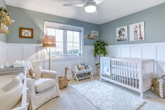 a baby's room with blue walls and white furniture