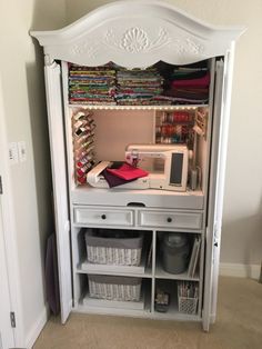 a sewing machine is sitting on top of a white cabinet