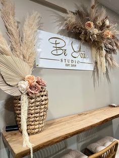 a wooden shelf with flowers and feathers on it