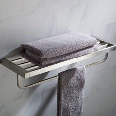 a towel rack with two folded towels on it