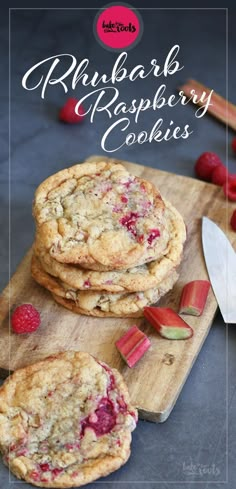 rhubarb raspberry cookies are stacked on a cutting board with strawberries