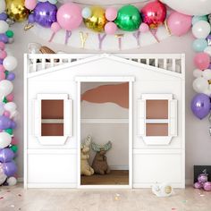 a room filled with balloons and decorations for a baby's first birthday or party