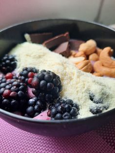 a bowl filled with different types of food on top of a purple table cloth,