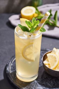 a drink with lemons and mint on the side