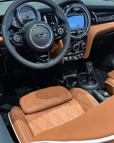 the interior of a sports car with tan leather seats and steering wheel, dash lights, and gauges