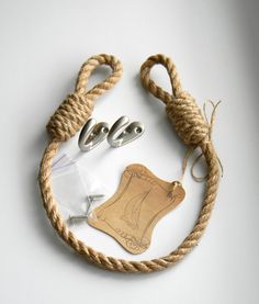 an image of a rope with scissors and other items attached to it on a white surface