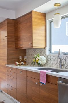 a kitchen with wooden cabinets and white counter tops