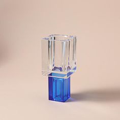 a blue glass vase sitting on top of a table