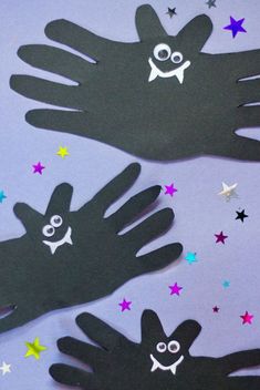 two handprints with faces and stars on them are shown in front of a purple background