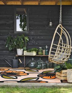 an outdoor area with potted plants and hanging chair