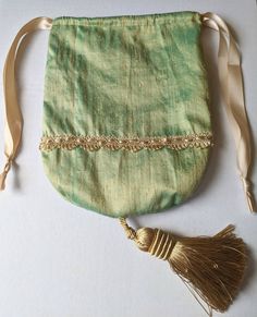 Handmade Regency Drawstring Reticule in colour and decoration of your choice.  If ordering a dress from myself I can make you a reticule to match with the same fabric and accessories (braiding, ribbon, beading, sequins etc) that are used to make you dress. Handmade Beige Pouch Potli Bag, Traditional Green Pouch Potli Bag, Traditional Green Potli Pouch Bag, Green Pouch Bag For Festivals, Handmade Green Shoulder Bag For Weddings, Handmade Green Shoulder Bag For Wedding, Green Pouch Potli Bag As Gift, Green Pouch Potli Bag For Gift, Elegant Green Potli Bag For Festivals