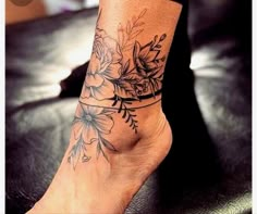 a woman's foot with flowers on it