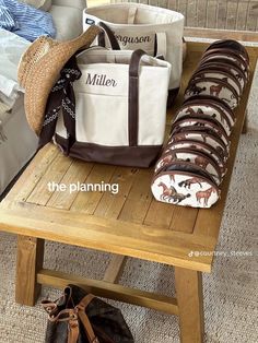 a wooden bench topped with lots of bags on top of it's side table