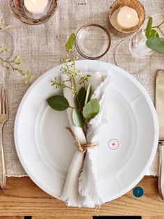 a white plate topped with a piece of paper next to a fork and knife on top of a wooden table