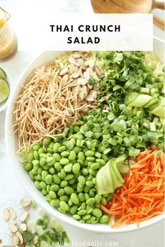 thai salad with carrots, broccoli and green beans in a white bowl