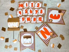 some cookies are laying out on the table and decorated with letters, numbers, and shapes