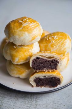 several pastries are stacked on top of each other in the middle of a plate