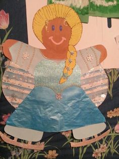 an image of a child's paper doll made out of scrapbook pages with flowers