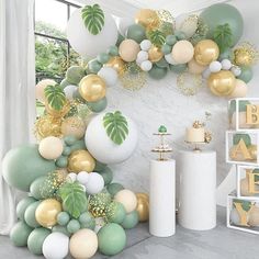 a room filled with balloons and greenery