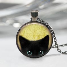 Handmade art pendant necklace featuring a peeking black kitten. You can choose your finish between antique bronze, antique silver, gunmetal or antique copper. This beautiful pendant is handcrafted by me... using a high quality art print image and is protected by a beautiful crystal clear domed glass cabochon which enhances the image for a truly stunning effect! The glass cabochon measures approximately 1 inch in diameter. The pendant and chain are nickel-free plated alloy and are available in an Resin Petals, Black Cat Jewelry, Black Cat Necklace, Cat Apparel, Halloween Pendant, Black Kitty, Necklace Cute, Black Kitten, Tree Necklace