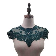 a white mannequin with green lace on it's neck and shoulderline