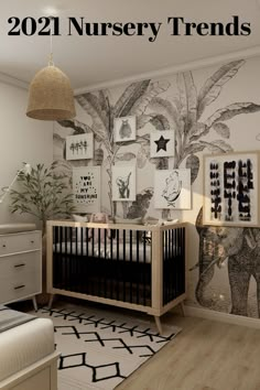 a baby's room decorated in black and white with pictures on the wall, including an elephant