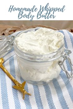 homemade tangerine whipped body butter in a glass jar on a blue and white towel