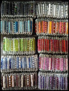 several rows of bracelets are stacked on top of each other in different colors and sizes