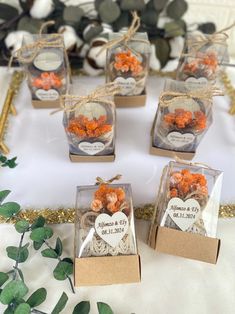 small clear boxes filled with orange flowers on top of a table