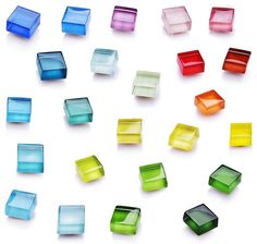 many different colored glass blocks on a white surface