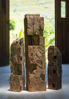 three pieces of wood stacked on top of each other in front of an open door