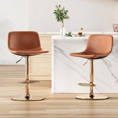 two brown barstools sitting in front of a marble counter