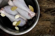 two raw chickens are in a pot on the table