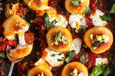 a close up of food on a plate with utensils and spoons in it