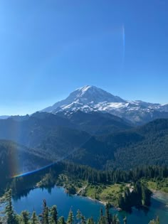 the sun shines brightly over a mountain lake