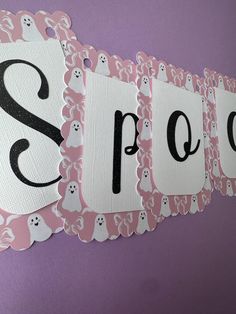 this is an image of a halloween themed name sign with ghost and ghost faces on it