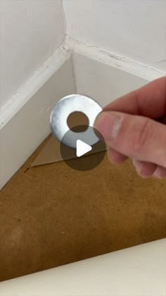 a hand pointing at a hole in the ceiling